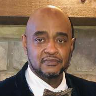 A picture of Reverend Roscoe C. Gudger Jr in a suit and bow tie.